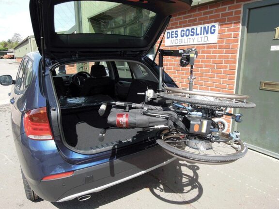 An open boot allows a Carolift 40 hoist to lift a sideways wheelchair into the back.