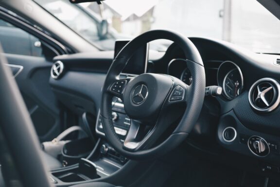 Steering wheel in a black Mercedes interior.