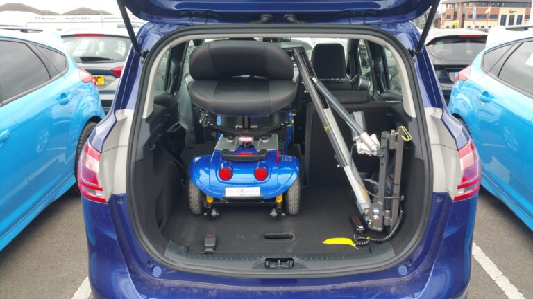 Smart Lifter LC hoist attached to a mobility scooter in the open boot of a car.