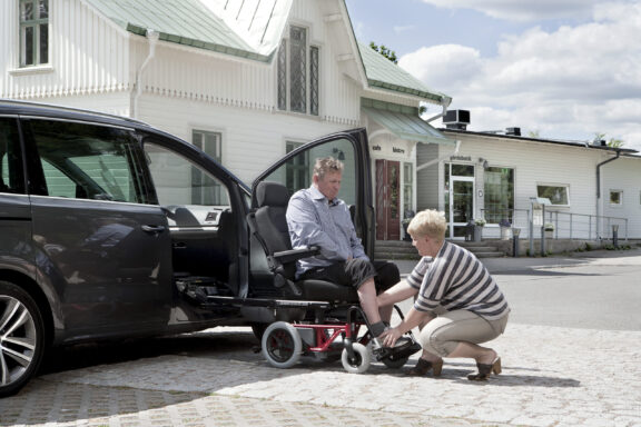 A driver is slid out of the driving position in their seat and onto a Carony base frame.