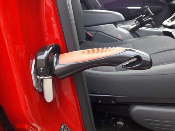 Carcane shown in normal operating position, slotted into the door latch to form a handle to help moving into and out of the car.