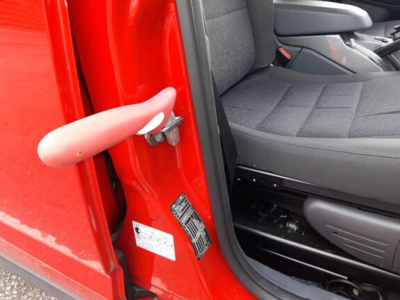 Handybar handle slotted into door latch.