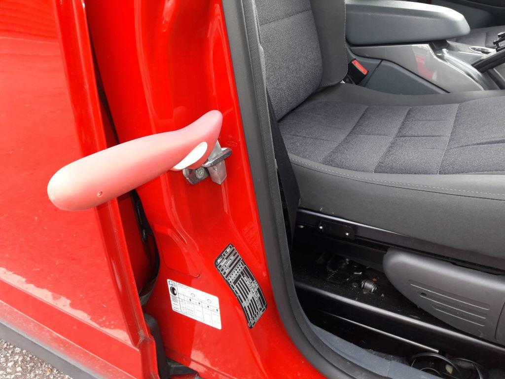 Handybar handle slotted into door latch.