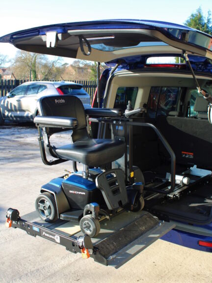 Joey Lift installed in a van with a scooter loaded in the upper position.