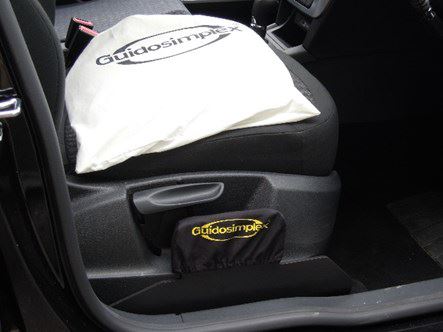 Seg Seat is stowed in a white canvas bag on the driver's seat, and a black cover is fitted over its slot next to the driver's seat.