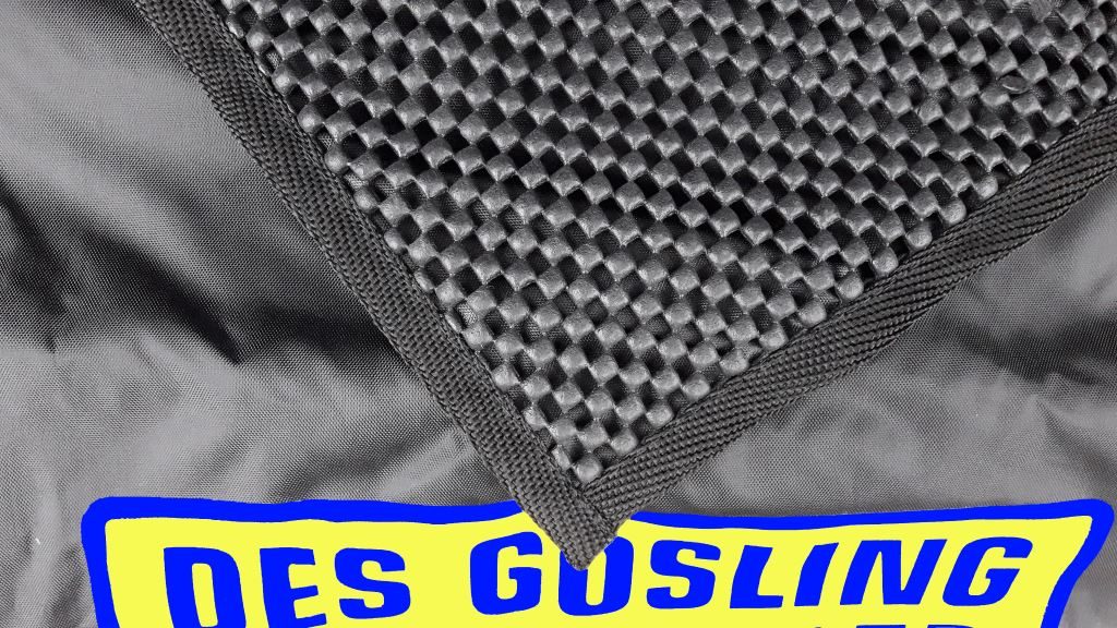 A Black fabric sill protector is shown with one corner folded over to show the underside, where there is a checkerboard pattern of raised and lowered area for grip.