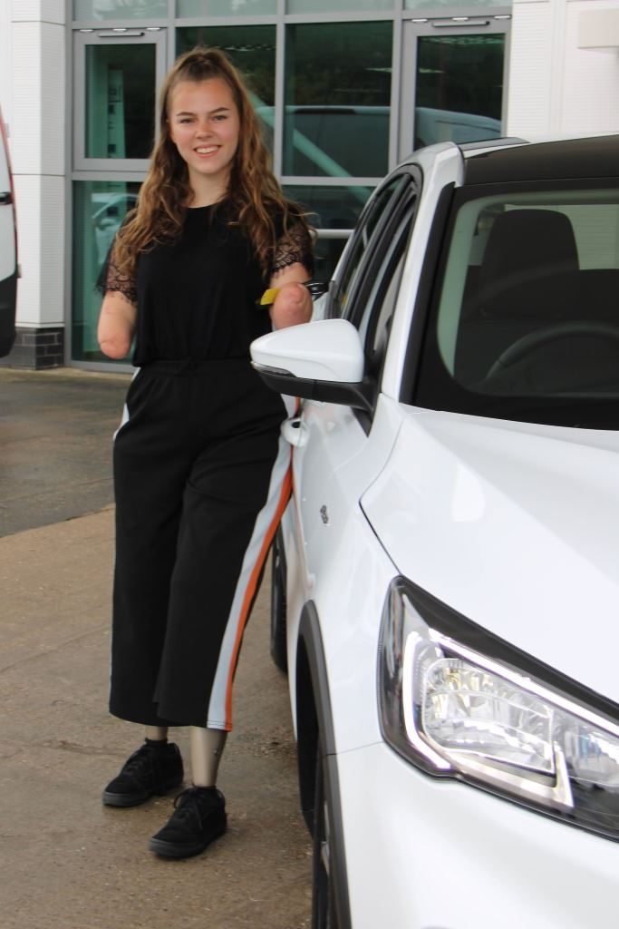 Izzy next to her new Ford Focus