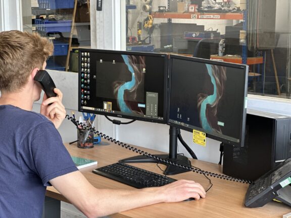 DGM Staff member on phone with customer
