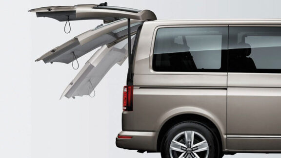 An open van boot is shown closing automatically.