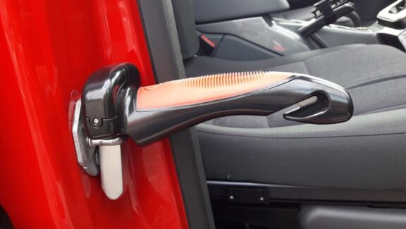 The Car Cane handle is shown slotted into the normal door securing latch.