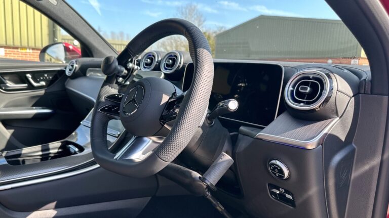 Mercedes interior shown with steering wheel adapted with Push/Pull hand controls and a steering ball.