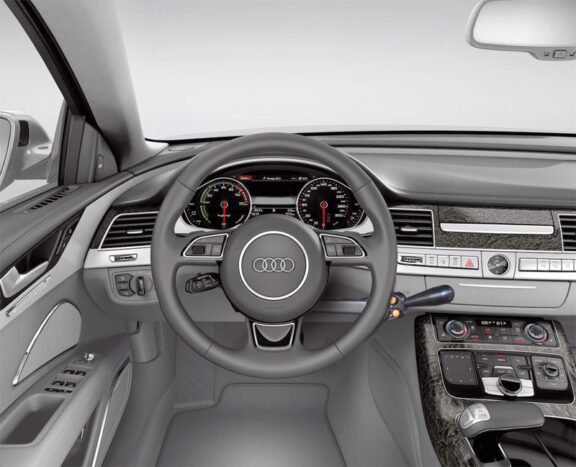 The radial accelerator and push brake is a black knob with two yellow buttons at the base fitted to the right of an Audi steering wheel.