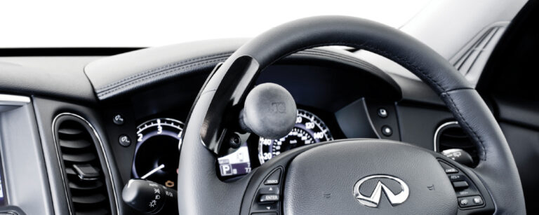 A steering aid with ball grip installed on a Lexus steering wheel.