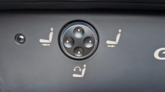 A 4 way switch on the side of the seat to control the position.
