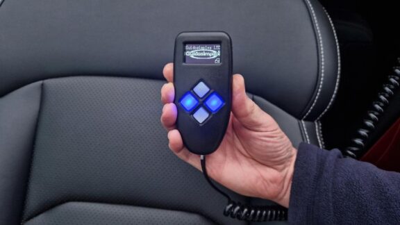 Handheld wired remote for the S-Tran swivel seat, with a small screen and 4 buttons in a diamond shape.