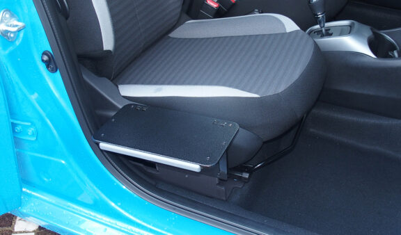 The foldable SEG seat transfer plate is shown unfolded to make a flat smooth surface for transferring across into the driver's seat.