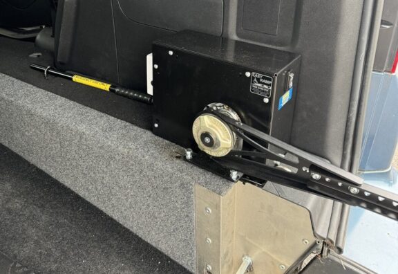 Close up of the easy ramp motor unit, a black metallic box with an arm attached.