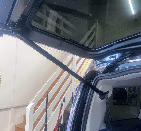 An arm attaches from the rear boot to the car's main body as part of the automatic booter.